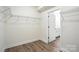 Large walk-in closet with shelving and wood-look floors leads to an ensuite bathroom at 4009 Grace Pointe Dr # 101, Indian Trail, NC 28079
