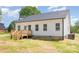 A modern home features a wooden deck, a well-maintained lawn, and a serene setting at 402 Walker St, Kannapolis, NC 28081