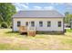 White home exterior with deck stairs, new lawn, and a modern look in a verdant location at 402 Walker St, Kannapolis, NC 28081
