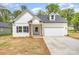 Inviting home with a well-manicured lawn, a classic white facade, and a convenient attached two-car garage at 402 Walker St, Kannapolis, NC 28081