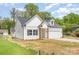 Charming home featuring a modern design, attached garage, inviting front porch, and a neatly maintained lawn at 402 Walker St, Kannapolis, NC 28081