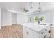 Bright kitchen area with an island and sink, modern flooring, recessed lighting, and large windows for natural light at 402 Walker St, Kannapolis, NC 28081