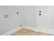 Bright laundry room featuring connections and modern, light-wood-look vinyl flooring at 402 Walker St, Kannapolis, NC 28081