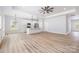 Bright open-concept area with modern flooring, recessed lighting, a ceiling fan, and a stylish kitchen island at 402 Walker St, Kannapolis, NC 28081