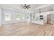 Spacious open-concept living area featuring modern flooring, a tray ceiling, and stainless steel appliances in the kitchen at 402 Walker St, Kannapolis, NC 28081