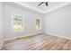Neutral primary bedroom with tray ceiling, ceiling fan, and light hardwood floors at 402 Walker St, Kannapolis, NC 28081