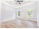Bright, spacious primary bedroom with tray ceiling, ceiling fan, and light-colored hardwood flooring at 402 Walker St, Kannapolis, NC 28081