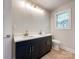 Bathroom boasts a modern vanity with dual sinks and cabinet, a toilet, and a light fixture at 418 Dallas Stanley Hwy, Dallas, NC 28034