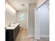 Bathroom boasts a modern vanity with dual sinks and cabinet, a toilet, and shower with glass door at 418 Dallas Stanley Hwy, Dallas, NC 28034