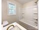 Bright bathroom features a shower-tub combination, toilet, and window providing natural light at 418 Dallas Stanley Hwy, Dallas, NC 28034