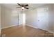 Bright bedroom features hardwood floors, neutral walls, ceiling fan, and natural light from the window at 418 Dallas Stanley Hwy, Dallas, NC 28034