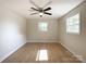Bright bedroom with hardwood floors, inviting natural light and a modern ceiling fan at 418 Dallas Stanley Hwy, Dallas, NC 28034