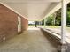 Long carport attached to the brick home at 418 Dallas Stanley Hwy, Dallas, NC 28034