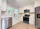 Modern kitchen featuring stainless steel appliances, white cabinets, and quartz countertops at 418 Dallas Stanley Hwy, Dallas, NC 28034