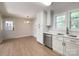 Bright kitchen with white cabinetry, stainless steel appliances, and a view into the dining area at 418 Dallas Stanley Hwy, Dallas, NC 28034