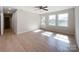 Living room with hardwood floors, neutral walls, ceiling fan, and natural light from multiple windows at 418 Dallas Stanley Hwy, Dallas, NC 28034