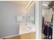 Bathroom featuring double sinks, a large mirror, and access to a walk-in closet at 504 Galesburg Dr, Monroe, NC 28110