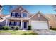 Charming two-story home features a two-car garage, well-maintained lawn, and dark shutters at 504 Galesburg Dr, Monroe, NC 28110