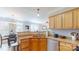 Kitchen boasts stainless steel appliances, a double sink, and wood cabinets at 504 Galesburg Dr, Monroe, NC 28110