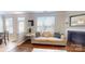Comfortable living room featuring a sofa, large window, and view of the fireplace at 504 Galesburg Dr, Monroe, NC 28110