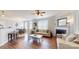 Open-concept living room with hardwood floors, a fireplace, and a view of the dining area at 504 Galesburg Dr, Monroe, NC 28110