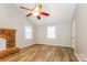 Bright, airy bedroom with hardwood flooring, a brick fireplace, and windows at 570 Scaleybark Rd, Rock Hill, SC 29732