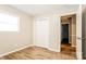 Bright bedroom featuring wood-look flooring, neutral paint, and a closet for ample storage space at 570 Scaleybark Rd, Rock Hill, SC 29732