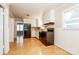Well-lit kitchen featuring white cabinets, appliances, backsplash, and hardwood floors at 570 Scaleybark Rd, Rock Hill, SC 29732