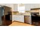 Kitchen with stainless steel appliances, tile backsplash, and well-maintained white cabinetry at 570 Scaleybark Rd, Rock Hill, SC 29732