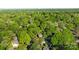 Aerial view of the property from high above showing the home nestled among lush green trees and the city in the distance at 6117 Brace Rd, Charlotte, NC 28211