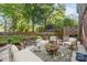 Cozy outdoor patio with dining table, sofa, and outdoor rug at 6117 Brace Rd, Charlotte, NC 28211