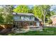 Spacious backyard with stone patio, fire pit, green grass and back of home at 6117 Brace Rd, Charlotte, NC 28211