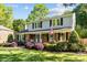 Beautiful two-story home with brick and siding, a manicured lawn, and mature landscaping at 6117 Brace Rd, Charlotte, NC 28211