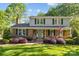 Inviting two-story home with brick facade, shutters, and landscaped front yard at 6117 Brace Rd, Charlotte, NC 28211