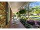 Cozy front porch with brick flooring, rocking chairs, and lush landscaping at 6117 Brace Rd, Charlotte, NC 28211