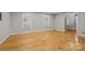 Spacious living room featuring gleaming hardwood floors and plenty of natural light from the windows at 6117 Brace Rd, Charlotte, NC 28211