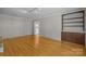Empty living room with hardwood floors and built-in shelving at 6117 Brace Rd, Charlotte, NC 28211