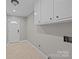 Convenient mudroom with tile floor, storage cabinets and access door to exterior at 6117 Brace Rd, Charlotte, NC 28211