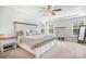 Comfortable bedroom with a large bed, ceiling fan, and bright windows with blinds at 835 Yucatan Dr, Waxhaw, NC 28173