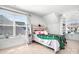 Bright bedroom with a large window, built-in shelves, and a cozy bed with a decorative green blanket at 835 Yucatan Dr, Waxhaw, NC 28173