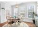 Bright dining room with wooden table, chairs, decorative rug, and large windows at 835 Yucatan Dr, Waxhaw, NC 28173