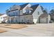 Charming two-story home featuring stone and siding accents, a three-car garage, and a well-manicured lawn at 835 Yucatan Dr, Waxhaw, NC 28173