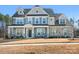 Stunning two-story home with a manicured lawn and a welcoming front porch showing incredible curb appeal at 835 Yucatan Dr, Waxhaw, NC 28173