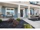 Cozy front porch featuring stone columns, rocking chairs, and seasonal decor, inviting guests to relax and enjoy the outdoors at 835 Yucatan Dr, Waxhaw, NC 28173