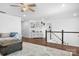 Bright open loft with wood floors, a ceiling fan, stairway, and white shiplap at 835 Yucatan Dr, Waxhaw, NC 28173