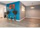 Open-concept living and dining area with trendy floors, bright accent wall, and tasteful decor at 9427 S Vicksburg Park Ct, Charlotte, NC 28210
