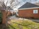 Entrance to the community pool behind a brick wall and black fence, along with lush green grass at 9427 S Vicksburg Park Ct, Charlotte, NC 28210