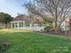 Community pool area featuring a fenced pool and covered seating areas on a sunny day at 9427 S Vicksburg Park Ct, Charlotte, NC 28210