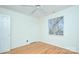 Light bedroom features hardwood floors, a ceiling fan and a window with natural light and two doors at 101 S Laurel Ave # 72A, Charlotte, NC 28207