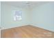 Bright, airy bedroom features hardwood floors, a ceiling fan and a window with natural light at 101 S Laurel Ave # 72A, Charlotte, NC 28207